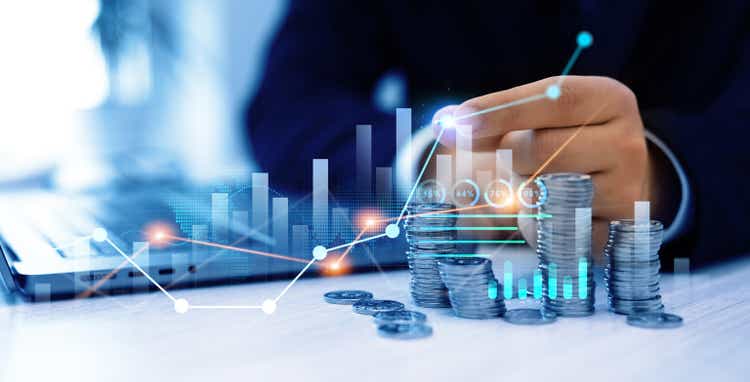 Financial growth data or investment market profit bar and success report.Businessman putting money coin stack with growing business graph. Saving money concept.