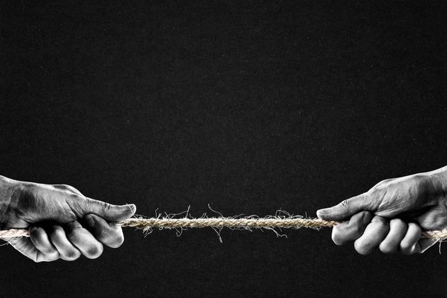 Hands Pulling Rope to Opposite Sides