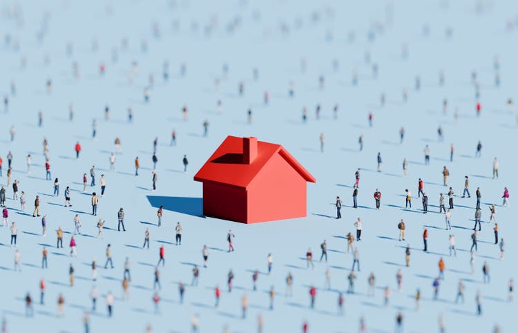 Oversized housing symbol surrounded by people
