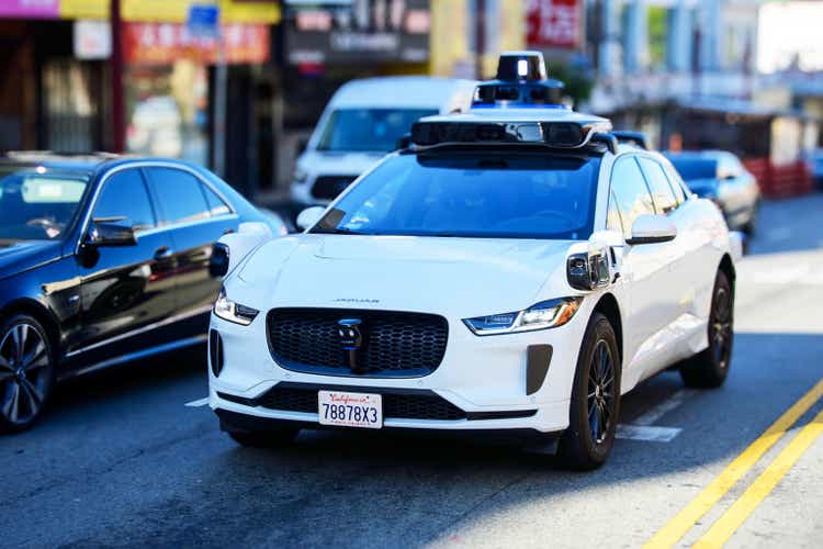 Waymo Jaguar driverless car drives on urban street in San Francisco