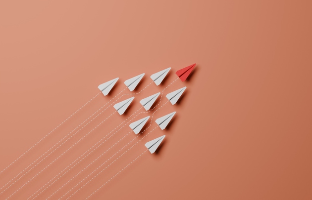 Group of paper planes with a leader