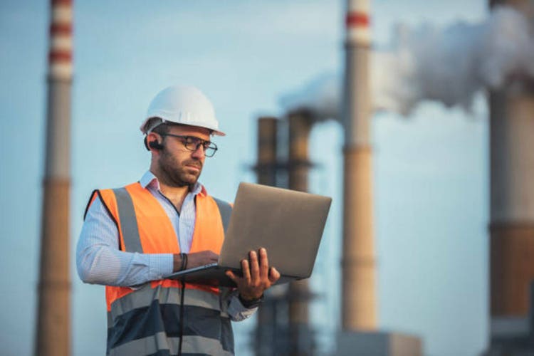 Engineer working at petrol refinery plant site.