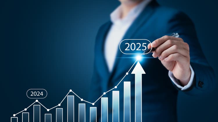 Businessman pointing at arrow graph New Year"s business goals for 2025.