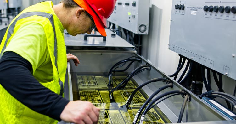 Technician Inspecting Server in Immersion Cooling Tank