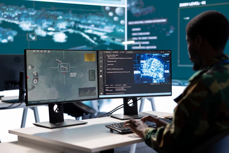Soldier working with AI intelligence on pc in control room