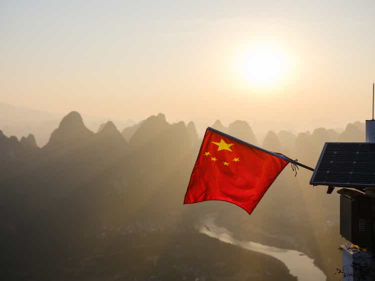 Scenic view of Chinese flag near Li River in Yangshuo County, Guilin at sunrise