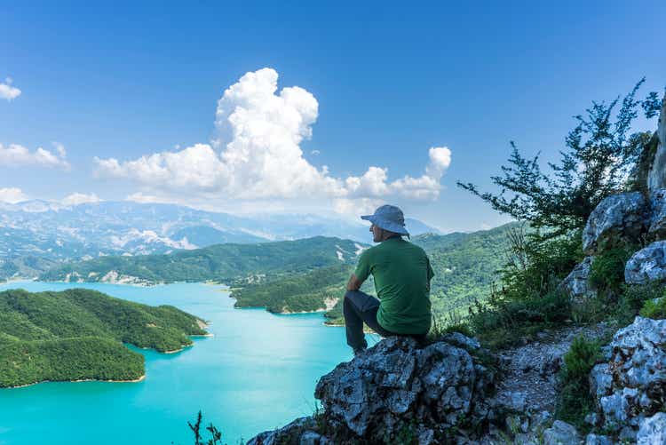 The traveler is resting on Mount Dajt, watching Bovilla Lake.