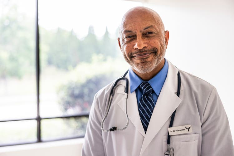 Portrait of male doctor in exam room