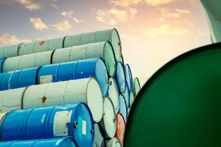 Old Chemical Barrels Stacking. Red, Green and Blue Chemical Barrel. Steel Tank With Flammable Liquid.