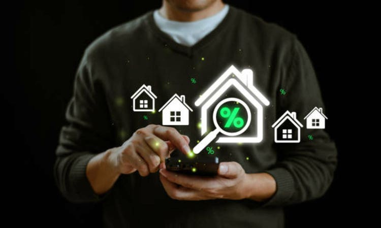 Financial interest rates, dividend investment concept. Business provision financial service. Man use smartphone with magnifying glass finding to house loan interest rate percentage icon, mortgage rise