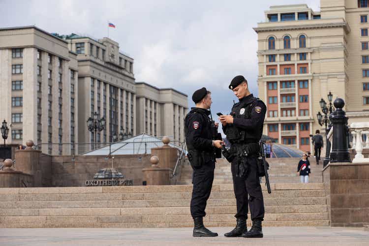 Two russian soldiers of special police forces patrolling the street against the State Duma building in Moscow