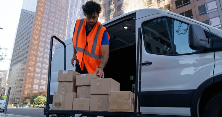 Low Angle Shot of Delivery Person Stacking Boxes on Platform Truck
