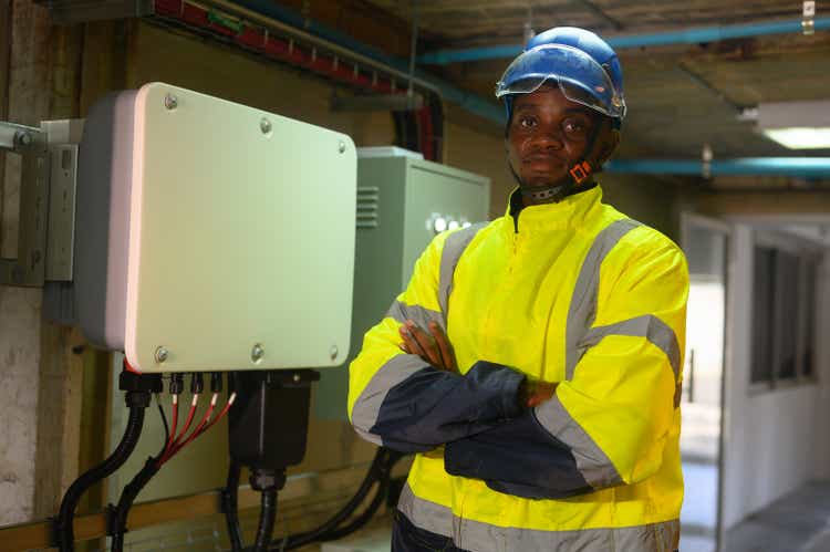 engineering technician Setting up the solar panel inverter in the electrical room Service engineer installs solar cells on factory roofs Concept of clean energy and renewable energy