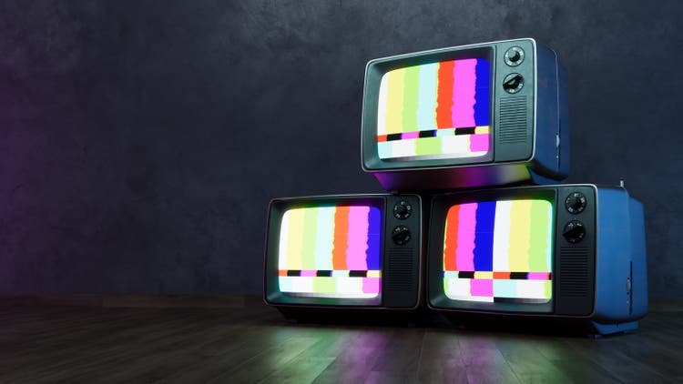 Stack of Vintage retro television on dark wooden background