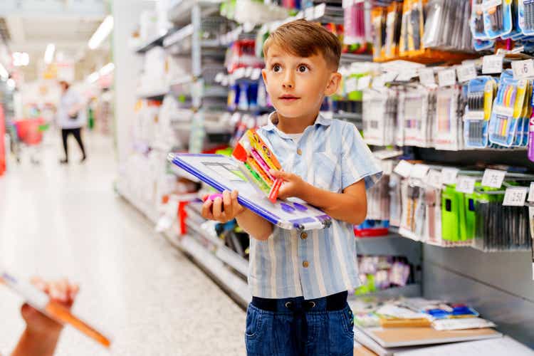 Mother her son at stationery shopping in a store, his son is angry because he didn"t get what he wanted