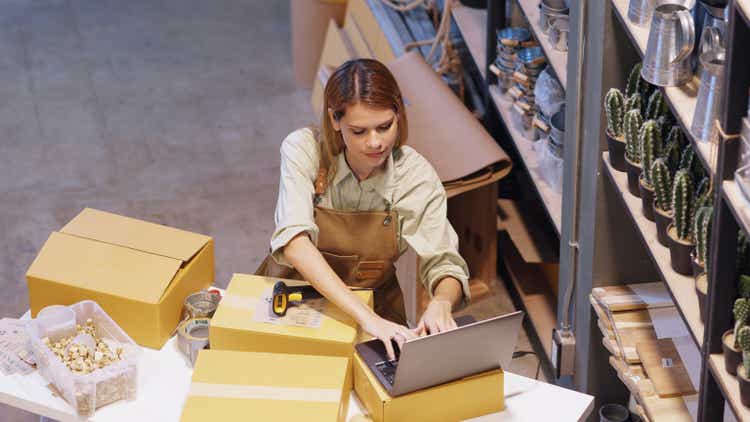 The grocery store warehouse manager working on laptop for confirm the delivery address for delivery after She 