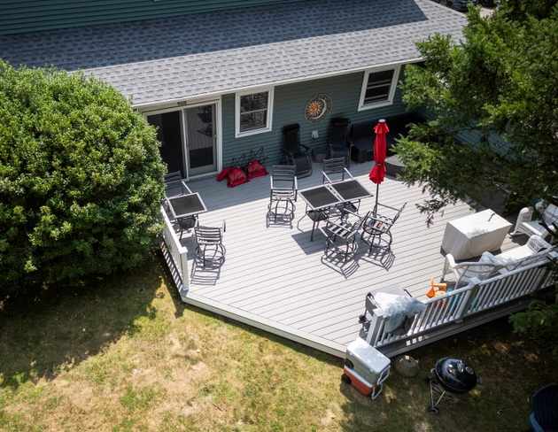 Drone view looking down at a deck on the back of a house