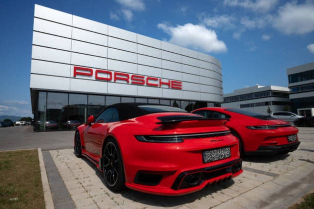 Porsche dealer with two red Porsche cars, one of which is a 911