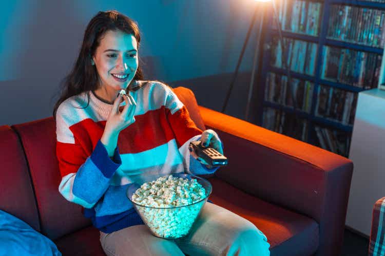 Woman enjoying a movie night at home with popcorn