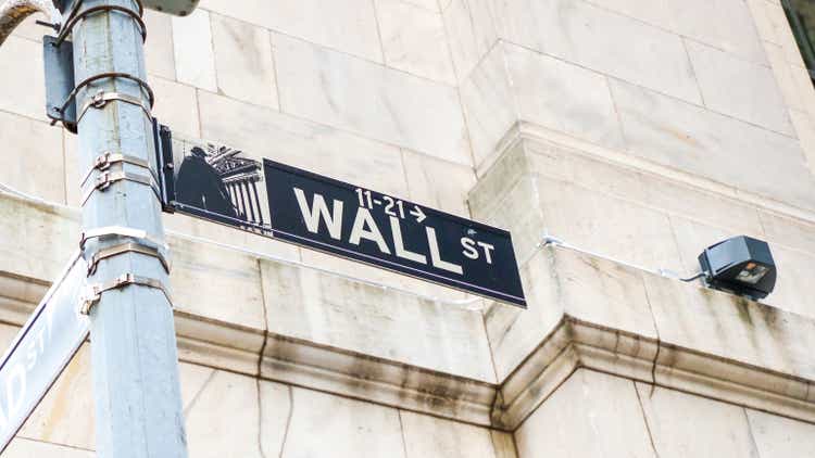 Road sign of New York Wall street corner Broad street.