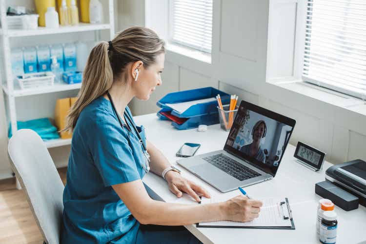 Doctor meeting remotely with her patient