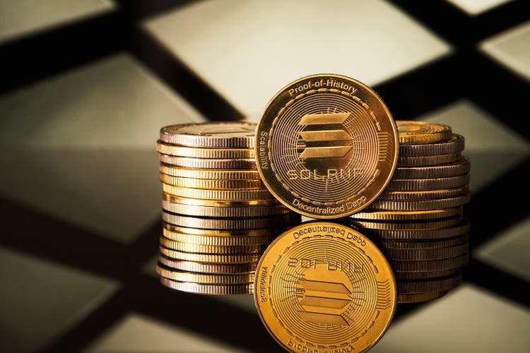 Golden Solana cryptocurrencies stacked on a geometric background that reflects light