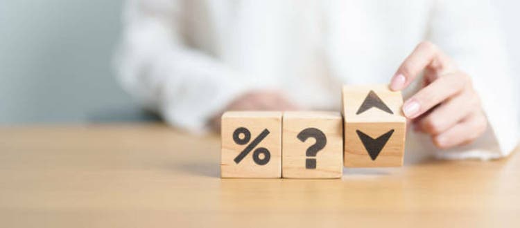 wood block of Question mark with percentage change to UP and Down arrow. Interest rate, GDP, stocks market, financial, deflation and Inflation, ranking, mortgage, debt, Loan and Economic Recession