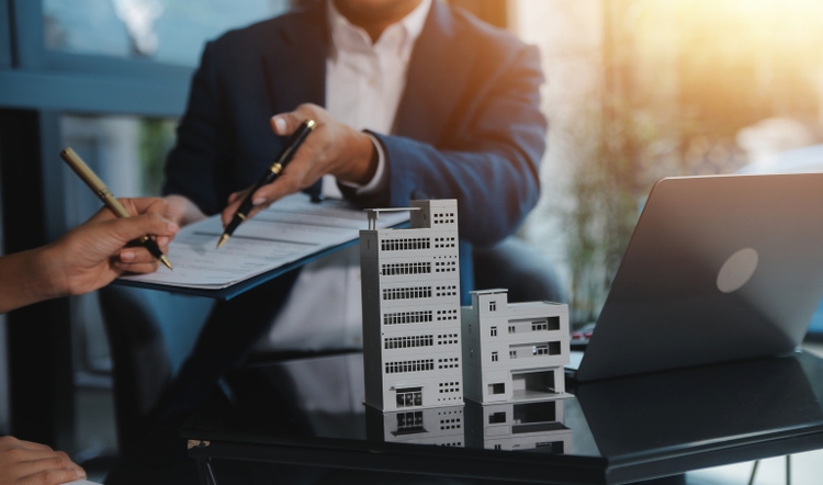 Real estate agent and customer signing contract to buy house, insurance or loan real estate.rent a house,get insurance or loan real estate or property.