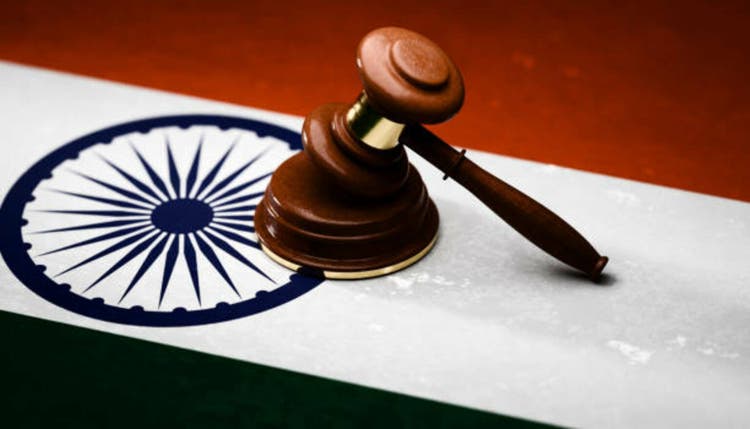 Gavel sitting on top of textured Indian flag