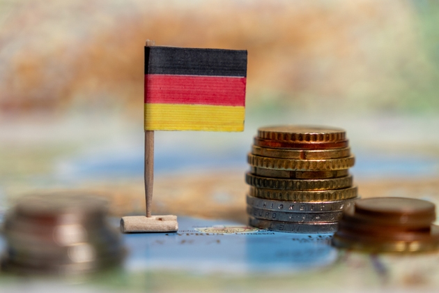 Close-up of German flag. Flag of Germany next to coins. Economy. Inflation and unemployment. Crisis