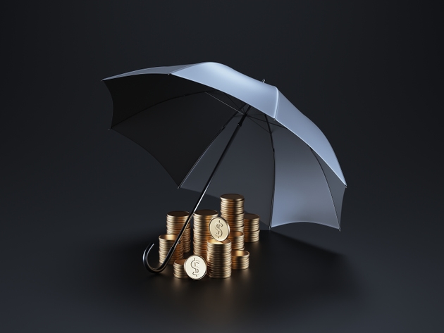 Stacks of coins under black umbrella