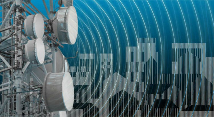ALERT ABOUT ELECTROMAGNETIC POLLUTION EXPOSURE IN A RESIDENTIAL AREA - Concept with base radio station for global communications services and electromagnetic emissions fields against a cityscape