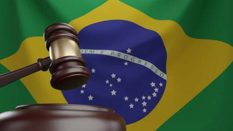 3d rendering of wooden court gavel, or auction hammer, with Brazil flag in the background.