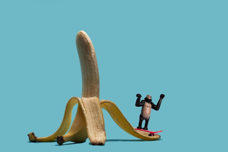 Toy gorilla skateboarding on a banana