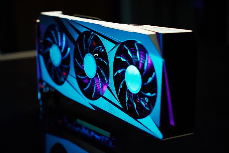 Modern gaming graphics card illuminated by neon lights