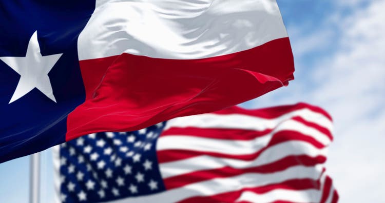 Texas state flags waving in the wind with american flag