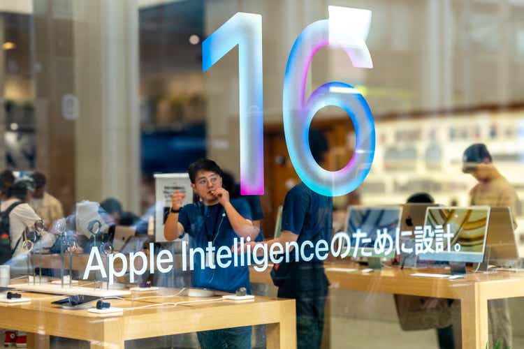 Tokyo, Japan, 09 30 2024: Apple Intelligence sign, with customers browsing inside Shinjuku"s Apple Store