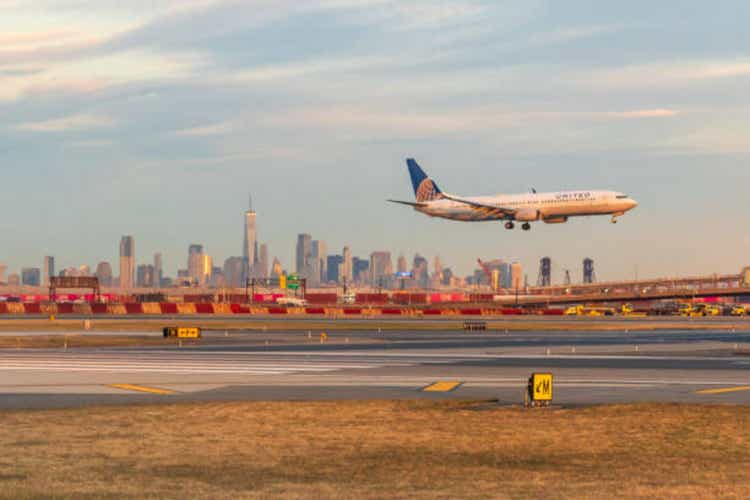 United Airways Jet lands in front of the Manhattan horizon