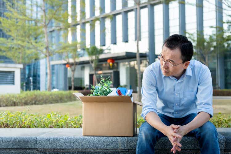 Unemployed man sitting outside the office building