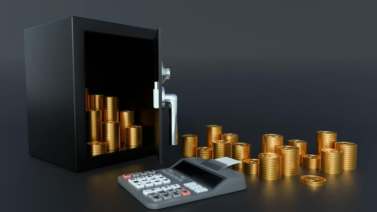 an open black safe with pile of gold coins and a classic calculator