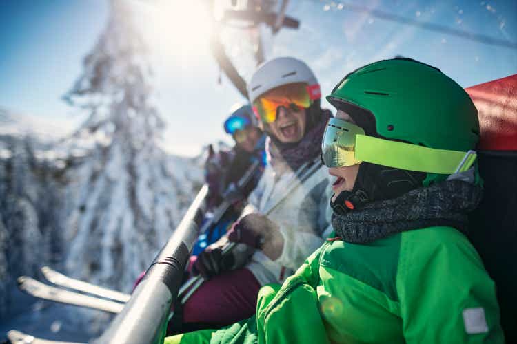 Family enjoying ski-lift ride together