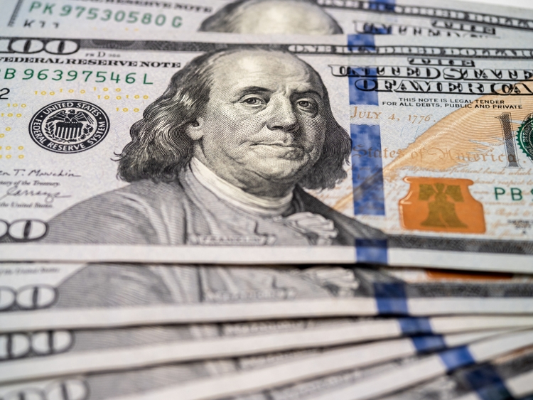 Close-up of inventor and U.S. founding father Benjamin Franklin"s portrait on 100 dollars bill banknote, money cash background. One hundred numbers on bill banknotes, piles.