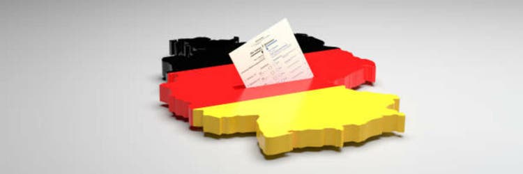 Elections in Germany. A sample ballot paper for the election to the Bundestag in the slit of a ballot box in the form of the German map with the German flag. 3d render, gray background, copy space