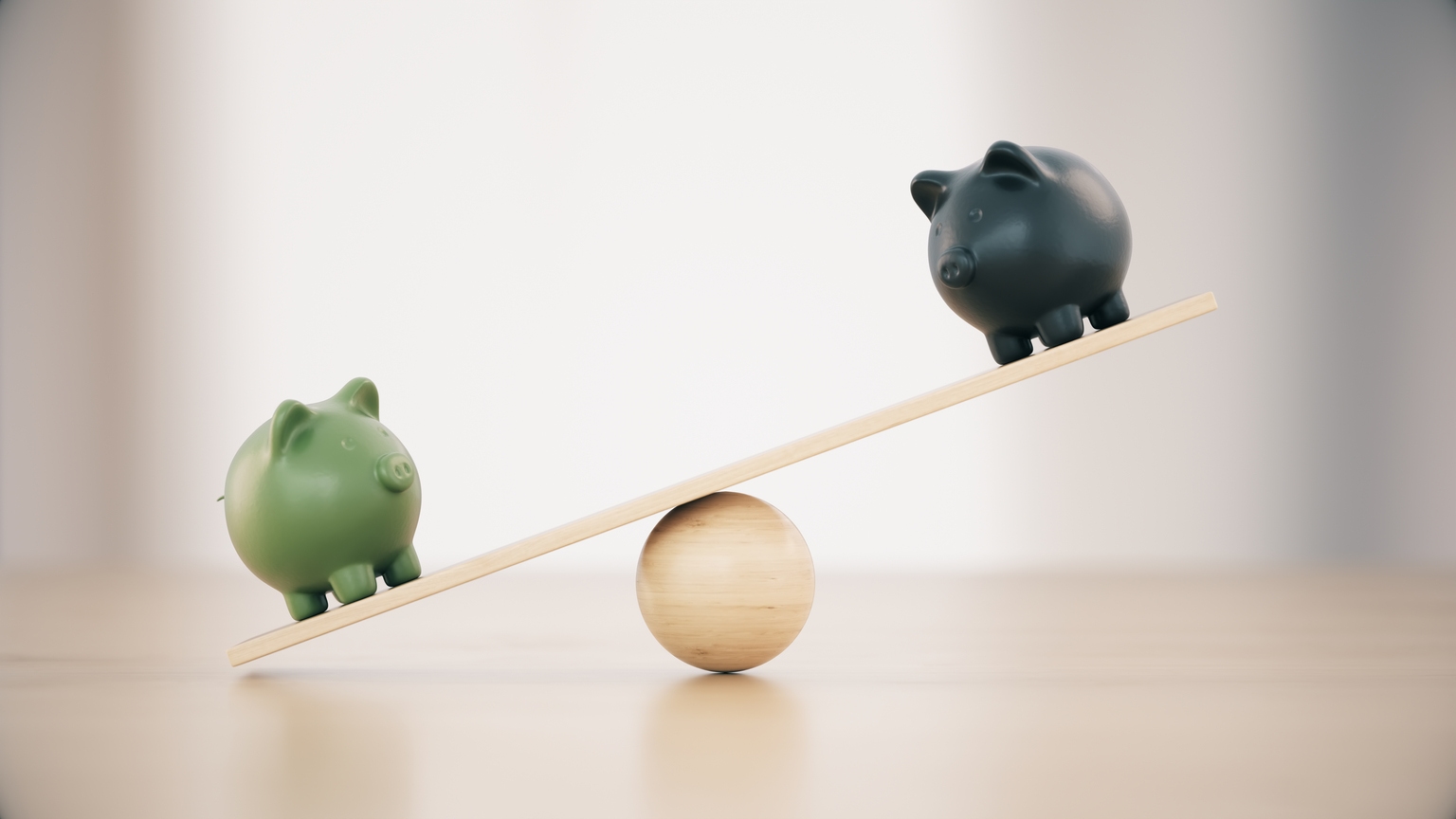 Green And Black Ceramic Piggy Banks On A Seesaw Before Defocused Wooden Background
