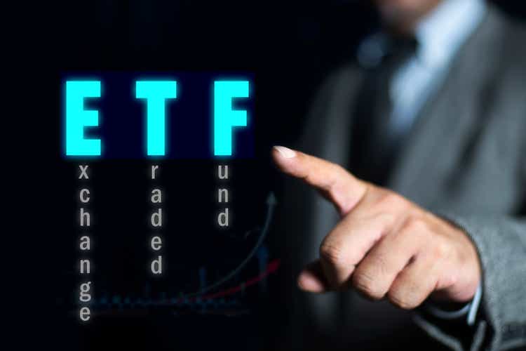 Businessman pointing at ETF (Exchange Traded Funds). Investment Opportunities in Mutual Funds and ETFs, Growing Wealth in the Financial Market.