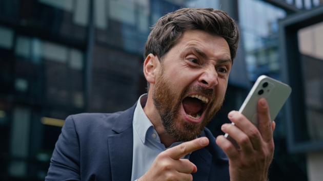 Annoyed mad crazy business man angry furious Caucasian businessman guy male boss employer aggressive irritated talk mobile phone shout scream yell cellphone conflict in city quarrel rage argue outdoor