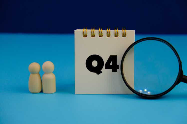 Close up of white notebook with alphabet Q4 on office desk. Fourth quarter concept.