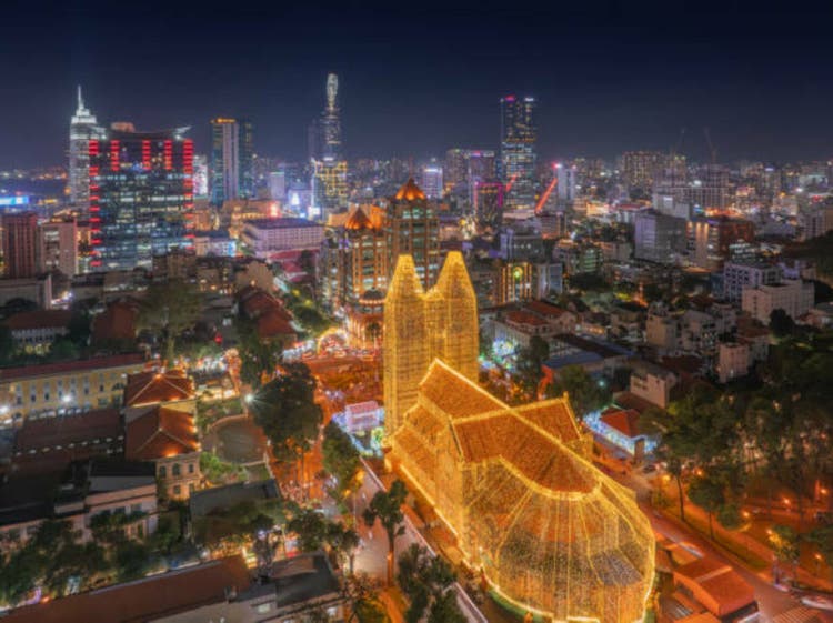 Aerial night view of a Ho Chi Minh City, Vietnam with development buildings, transportation, energy power infrastructure. Financial and business centers.
