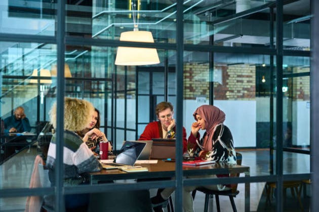 Diverse business colleagues in shared office space having meeting