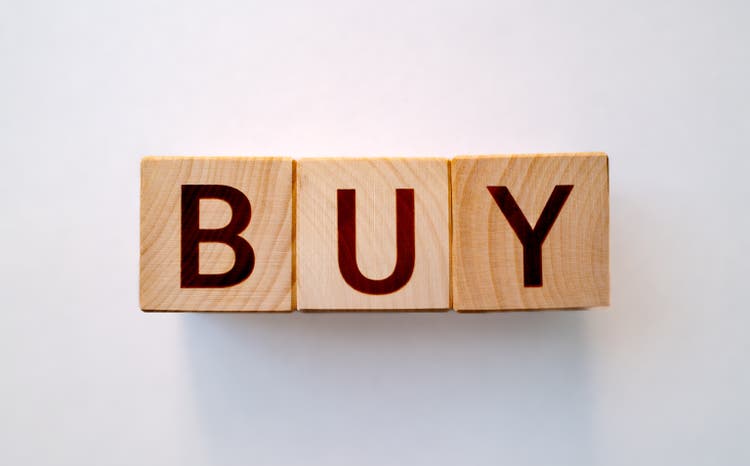 "Buy" word made by wooden blocks